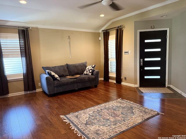 living room with dark hardwood / wood-style flooring, vaulted ceiling, ceiling fan, and ornamental molding