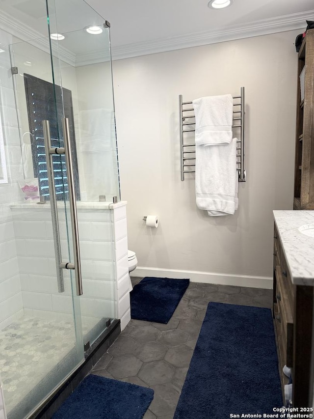 bathroom with vanity, ornamental molding, an enclosed shower, and toilet