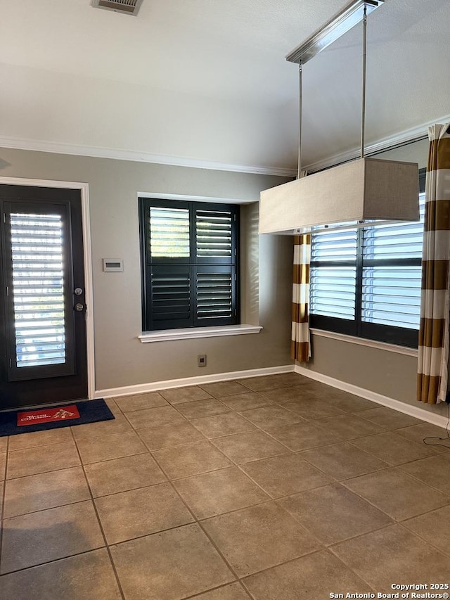 interior space featuring tile patterned flooring, plenty of natural light, and crown molding