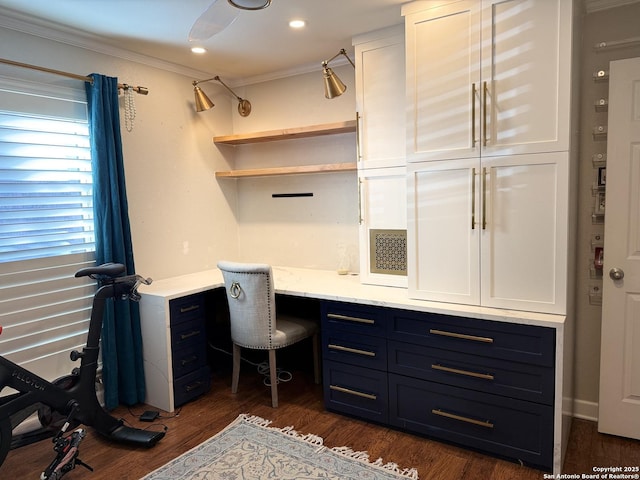 home office with dark hardwood / wood-style flooring, built in desk, and crown molding