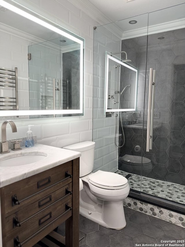 bathroom featuring radiator, tile patterned floors, toilet, vanity, and tile walls