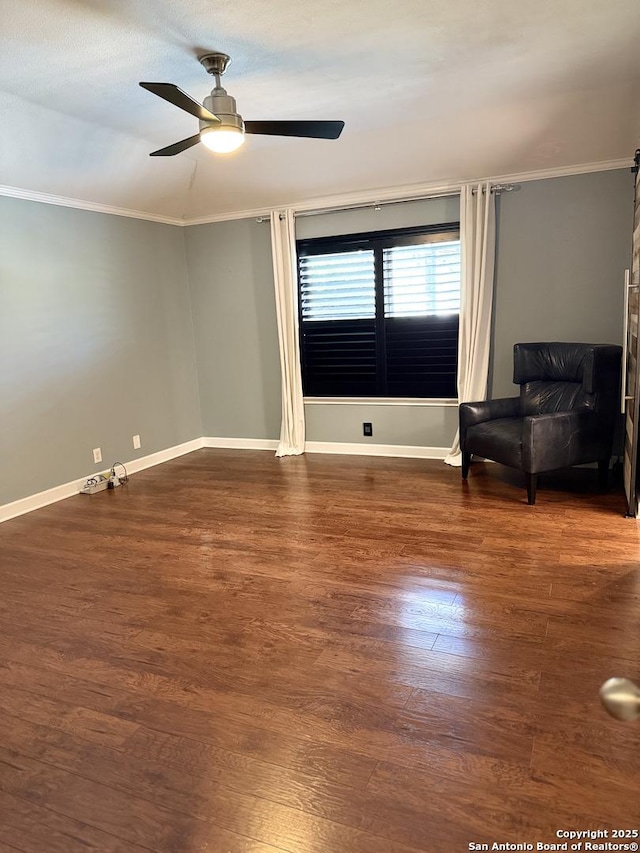 empty room with dark hardwood / wood-style flooring, ceiling fan, and crown molding