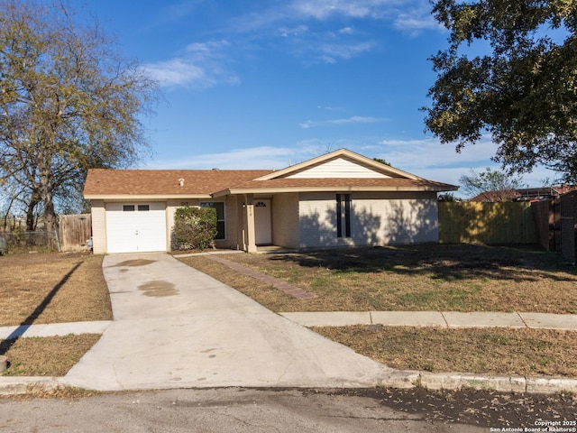 ranch-style house featuring a front yard and a garage