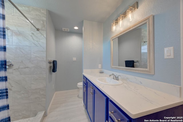 bathroom with vanity, toilet, and walk in shower