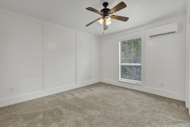 carpeted spare room featuring an AC wall unit and ceiling fan