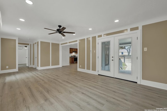 unfurnished living room featuring crown molding, ceiling fan, french doors, and light hardwood / wood-style floors