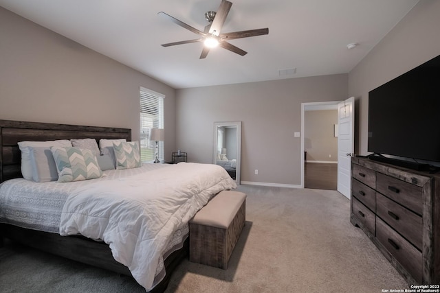 bedroom featuring light carpet, ceiling fan, visible vents, and baseboards