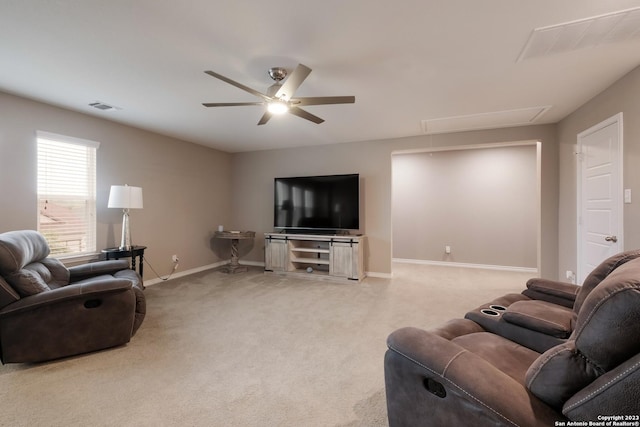 living area featuring visible vents, attic access, light carpet, ceiling fan, and baseboards