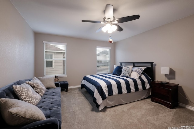 bedroom featuring baseboards, ceiling fan, and light colored carpet