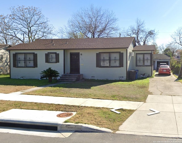 ranch-style home with a front lawn and a garage