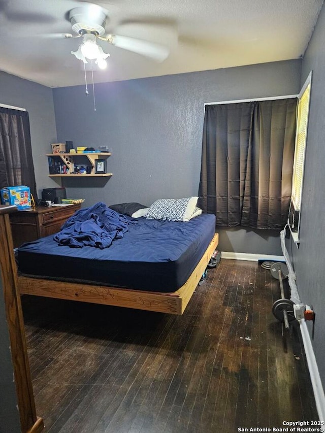 bedroom with hardwood / wood-style floors and ceiling fan