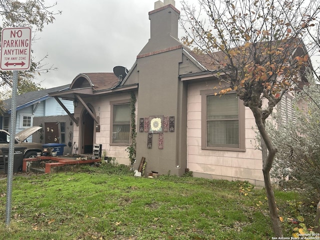 back of house with a lawn