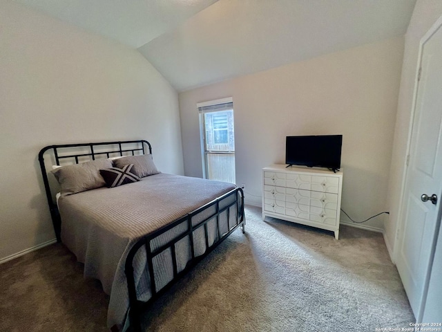 bedroom featuring dark colored carpet and lofted ceiling