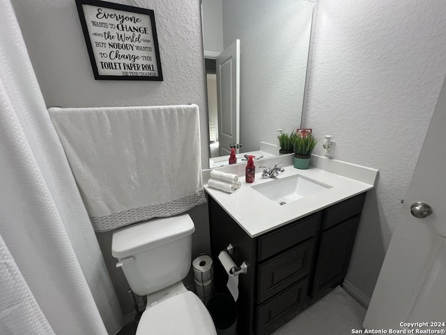 bathroom featuring vanity and toilet