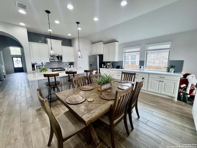 dining area with light hardwood / wood-style flooring and a healthy amount of sunlight