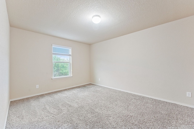 carpeted spare room featuring a textured ceiling