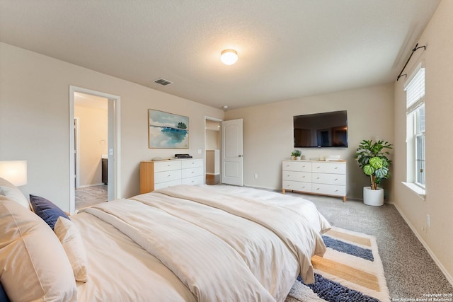 carpeted bedroom featuring ensuite bath