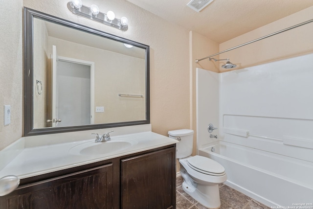 full bathroom with shower / washtub combination, vanity, a textured ceiling, and toilet