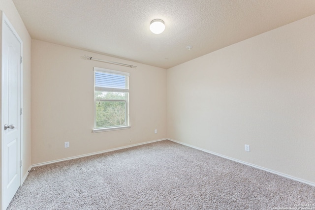 carpeted spare room featuring a textured ceiling