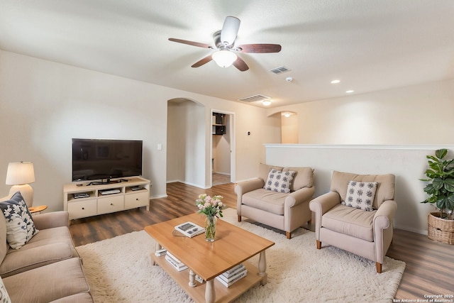 living room featuring hardwood / wood-style floors and ceiling fan