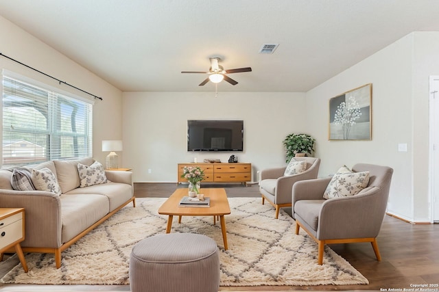 living room with hardwood / wood-style flooring and ceiling fan