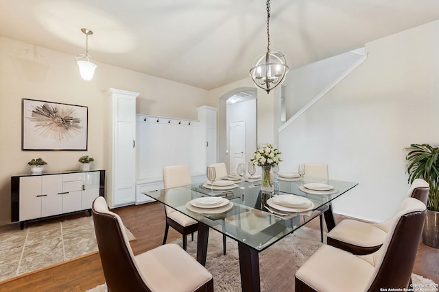 dining room with an inviting chandelier and hardwood / wood-style flooring