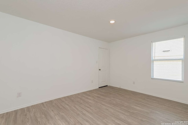 spare room with light hardwood / wood-style floors