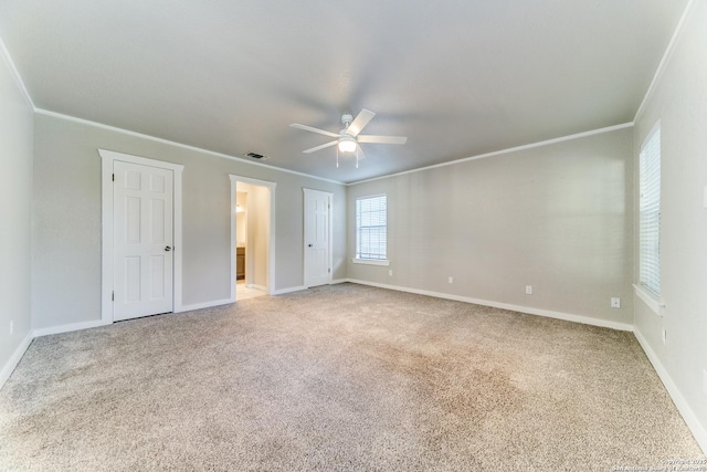 unfurnished bedroom featuring ceiling fan, carpet, and crown molding