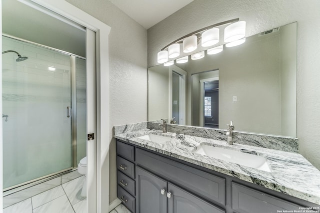 bathroom with toilet, an enclosed shower, and vanity