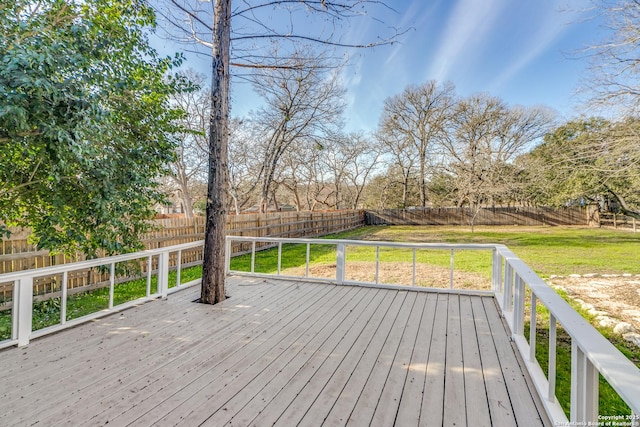 wooden terrace featuring a lawn