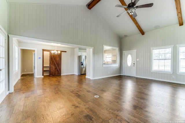 unfurnished living room featuring ceiling fan with notable chandelier, dark hardwood / wood-style floors, high vaulted ceiling, and beamed ceiling