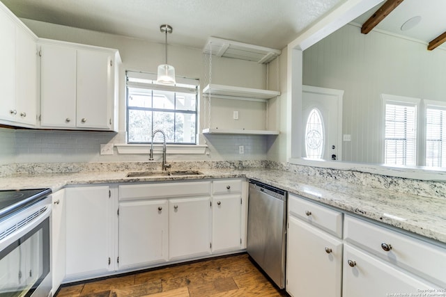 kitchen with stainless steel appliances, sink, white cabinetry, beamed ceiling, and pendant lighting