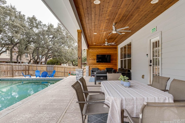 view of patio / terrace featuring a fenced in pool, ceiling fan, and an outdoor living space