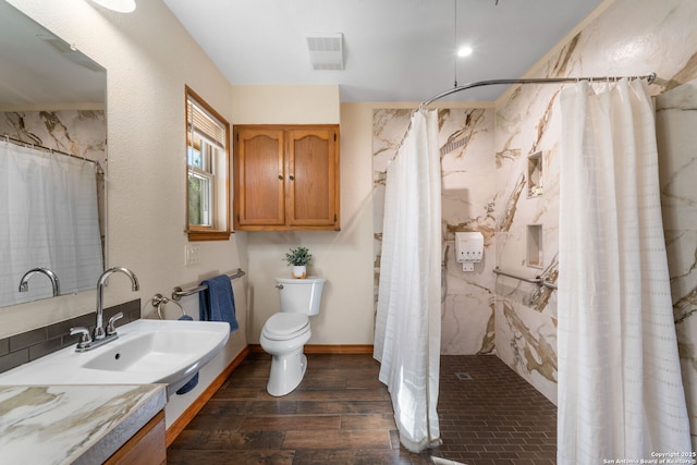 bathroom featuring sink, toilet, and walk in shower