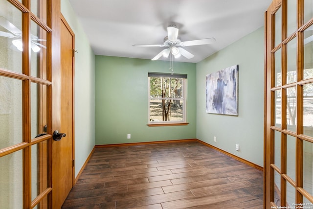 spare room with ceiling fan, dark hardwood / wood-style flooring, and french doors