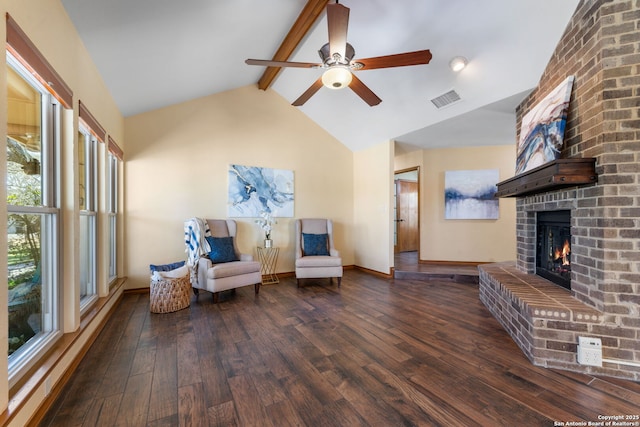 unfurnished room with ceiling fan, a fireplace, dark hardwood / wood-style flooring, and vaulted ceiling with beams