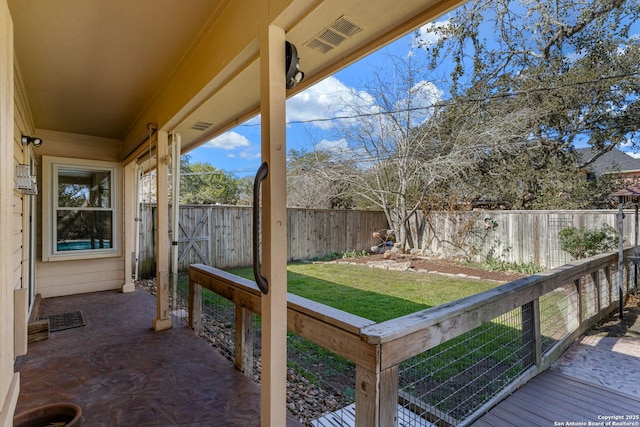 wooden terrace with a lawn