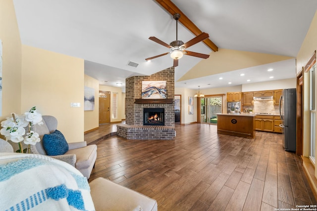 living room featuring a brick fireplace, vaulted ceiling with beams, hardwood / wood-style floors, and ceiling fan