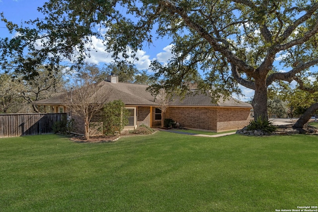 back of house with a lawn