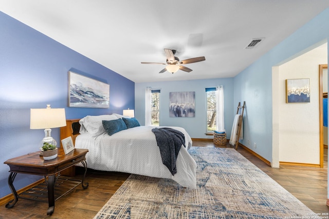 bedroom with dark hardwood / wood-style floors and ceiling fan