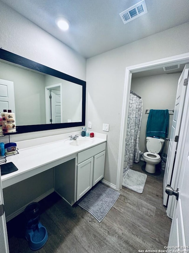 bathroom featuring hardwood / wood-style floors, vanity, and toilet