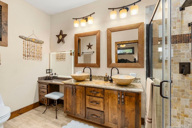 bathroom featuring toilet, walk in shower, and vanity