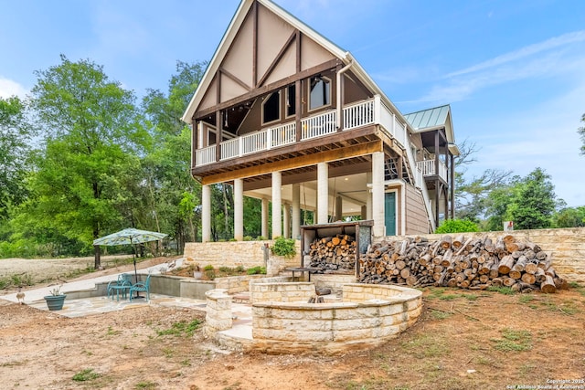 back of house featuring an outdoor fire pit and a patio area