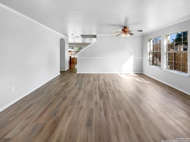 unfurnished living room featuring ceiling fan, dark hardwood / wood-style flooring, and crown molding