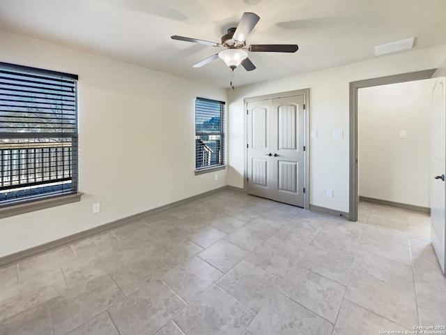 unfurnished bedroom featuring ceiling fan and a closet