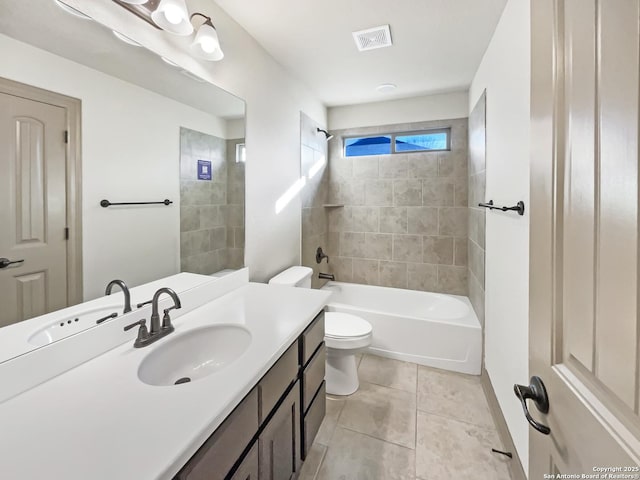 full bathroom with toilet, vanity, tile patterned floors, and tiled shower / bath combo