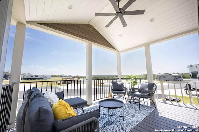 wooden terrace with an outdoor hangout area and ceiling fan