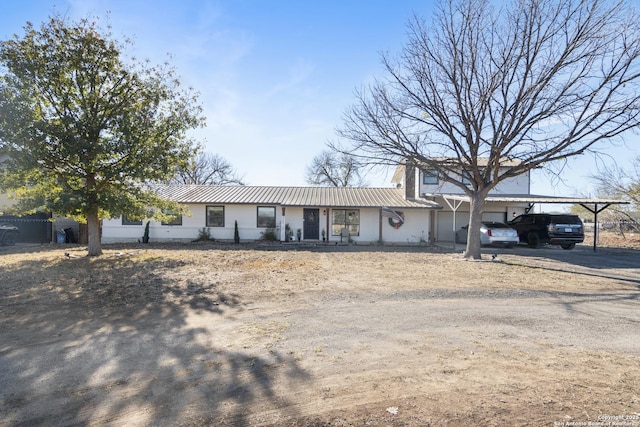 ranch-style home featuring a carport