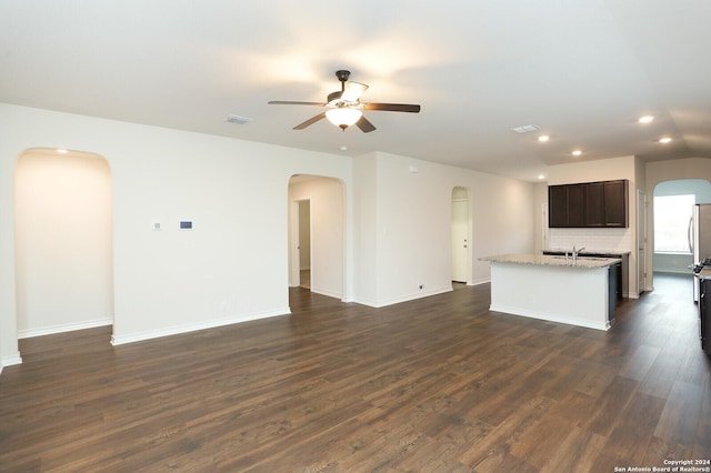 unfurnished living room with dark hardwood / wood-style floors and ceiling fan