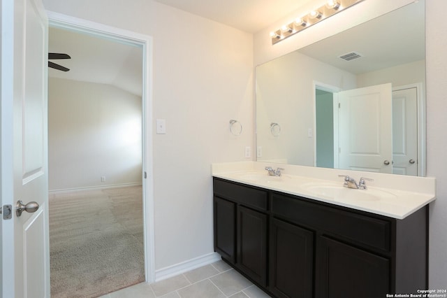 bathroom featuring tile patterned flooring, vanity, ceiling fan, and lofted ceiling